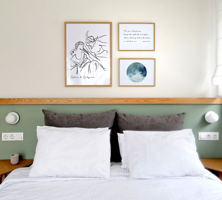 Wall art illustrations and frames that decorate the bedroom of a themed hotel. Design by The Blank Sheep